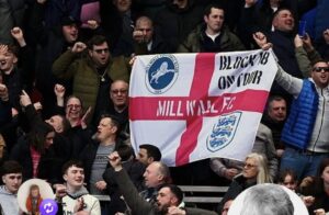 Football supporters displaying a St George Supporter flag at a football match