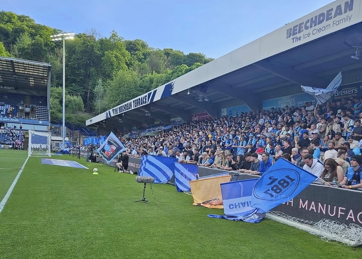 Custom football supporters flags displayed around a football stadium